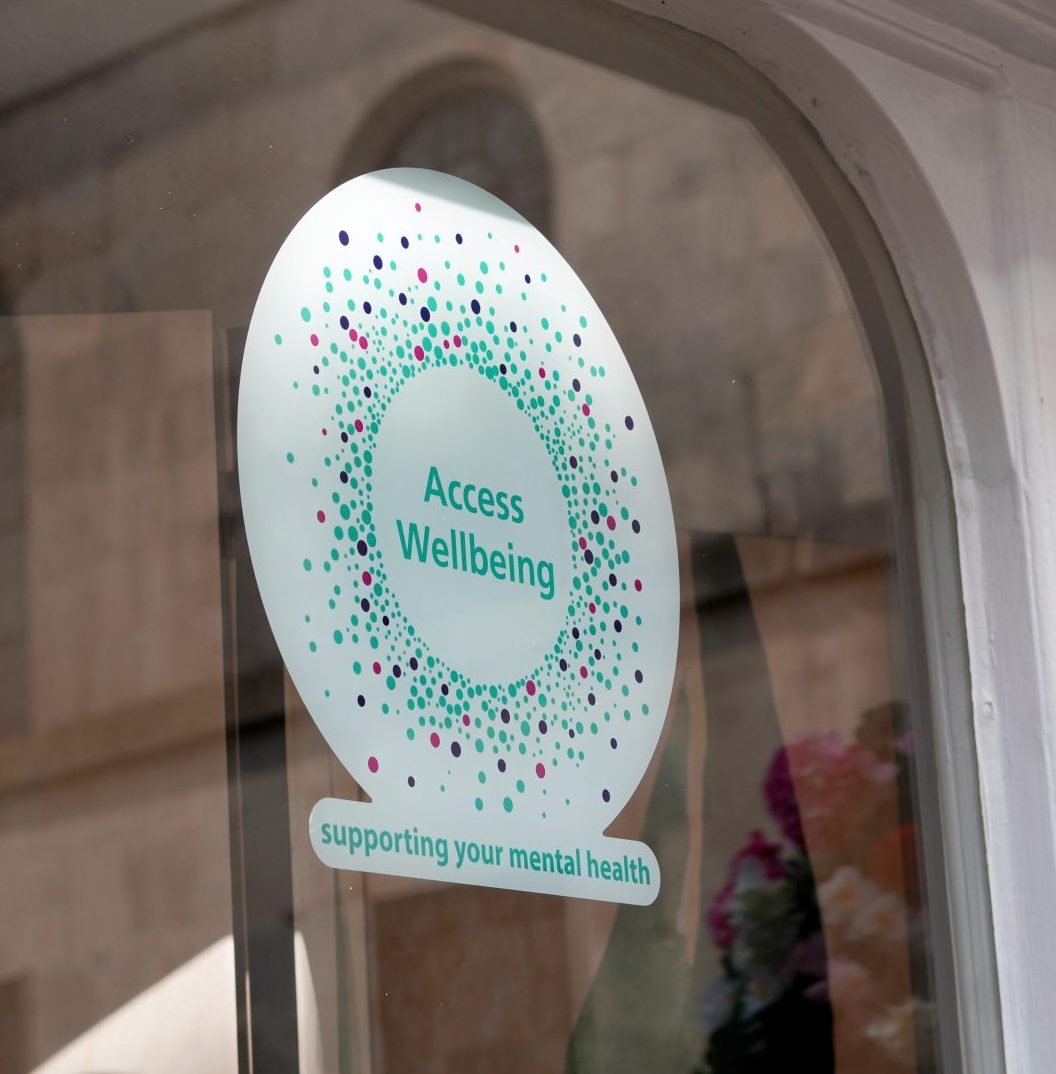 An Access Wellbeing logo on the window of the Lantern Community Hub